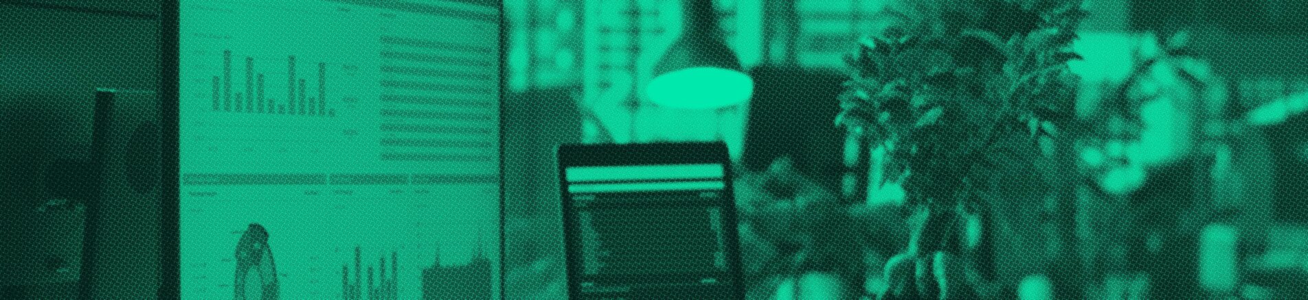 Reporting dashboards open across two monitors in an office