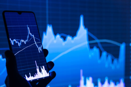 Stock market analysis on smartphone showing fluctuating graphs