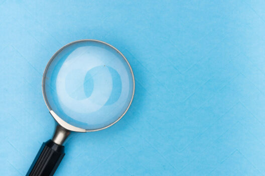Magnifying glass on blue background indicating search concept
