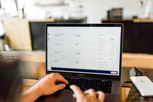 Person analyzing financial dashboard on laptop screen
