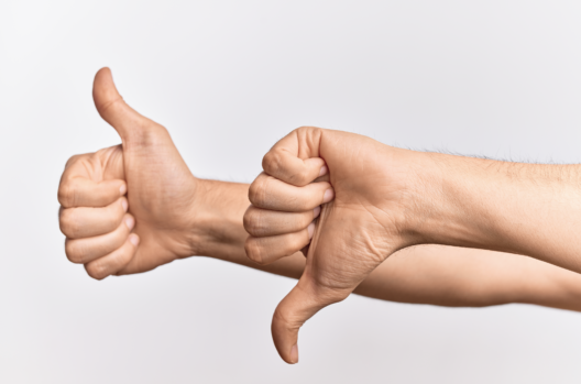Thumbs up and thumbs down hand gestures showing the pros and cons of selling on Walmart Marketplace